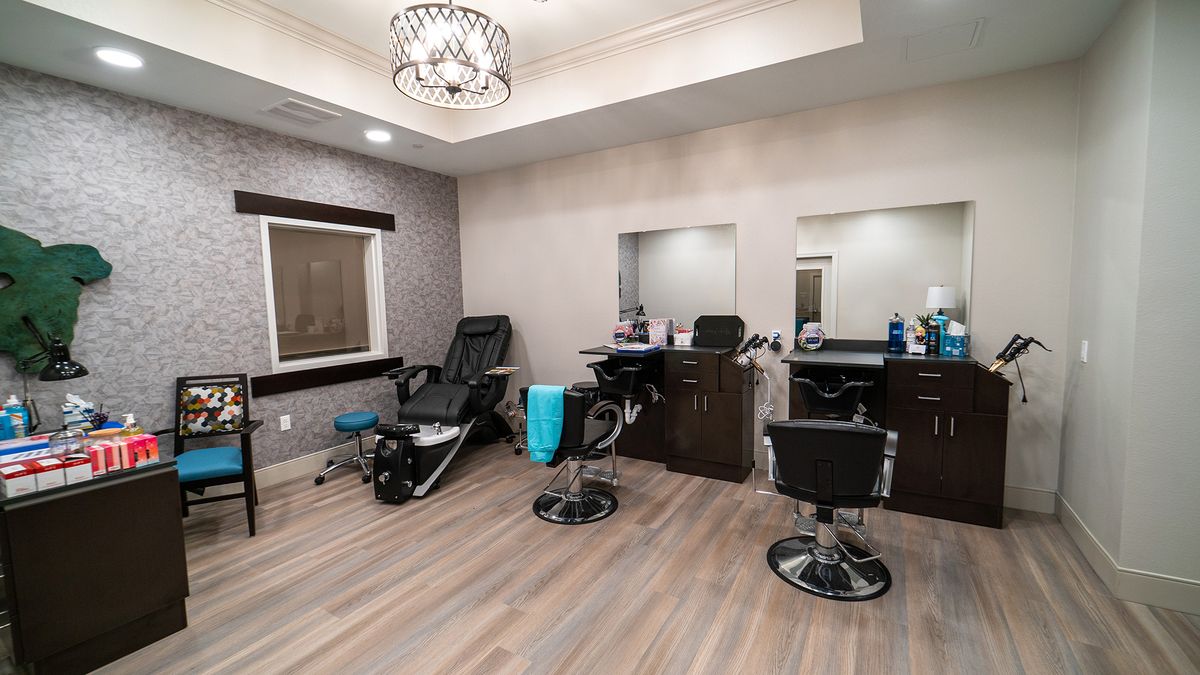 A modern salon interior with styling chairs and mirrors.
