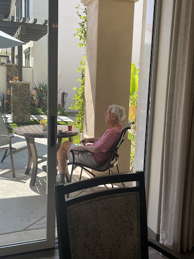 A senior person enjoying a peaceful moment in the garden, soaking up the sun.