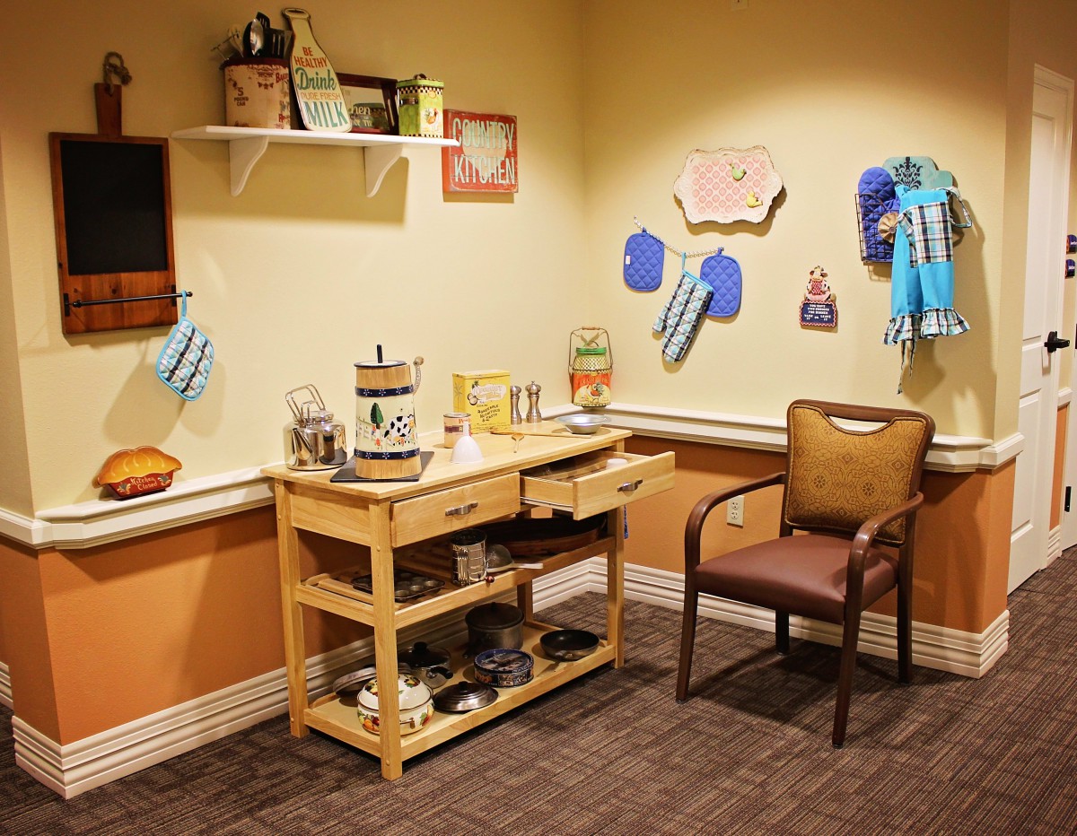 A cozy room with a wooden desk and chair, decorated with various items and wall hangings.