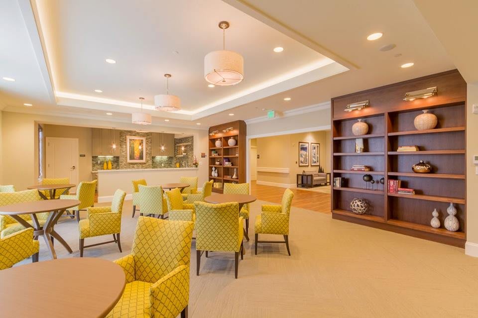 A modern and spacious dining area with comfortable seating and elegant lighting.