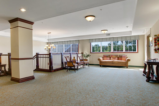 A spacious and well-lit lobby featuring comfortable seating and large windows.