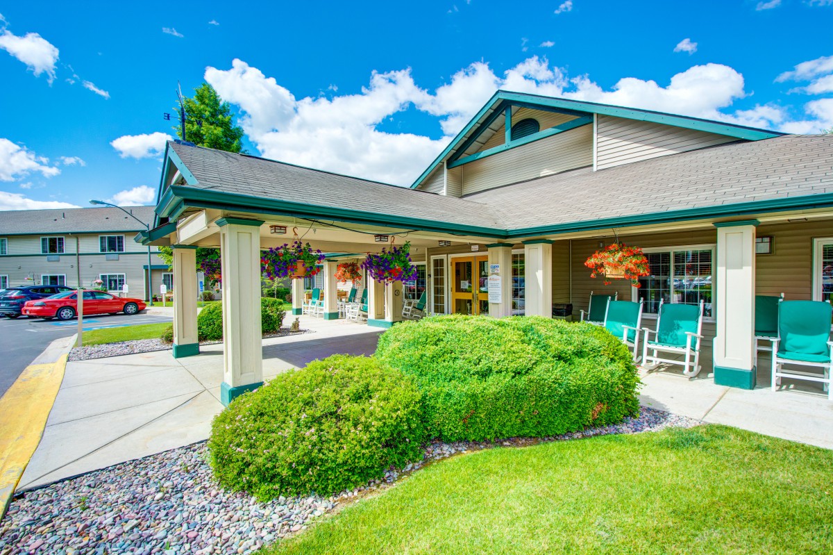 A well-maintained building with lush landscaping and a covered entrance.