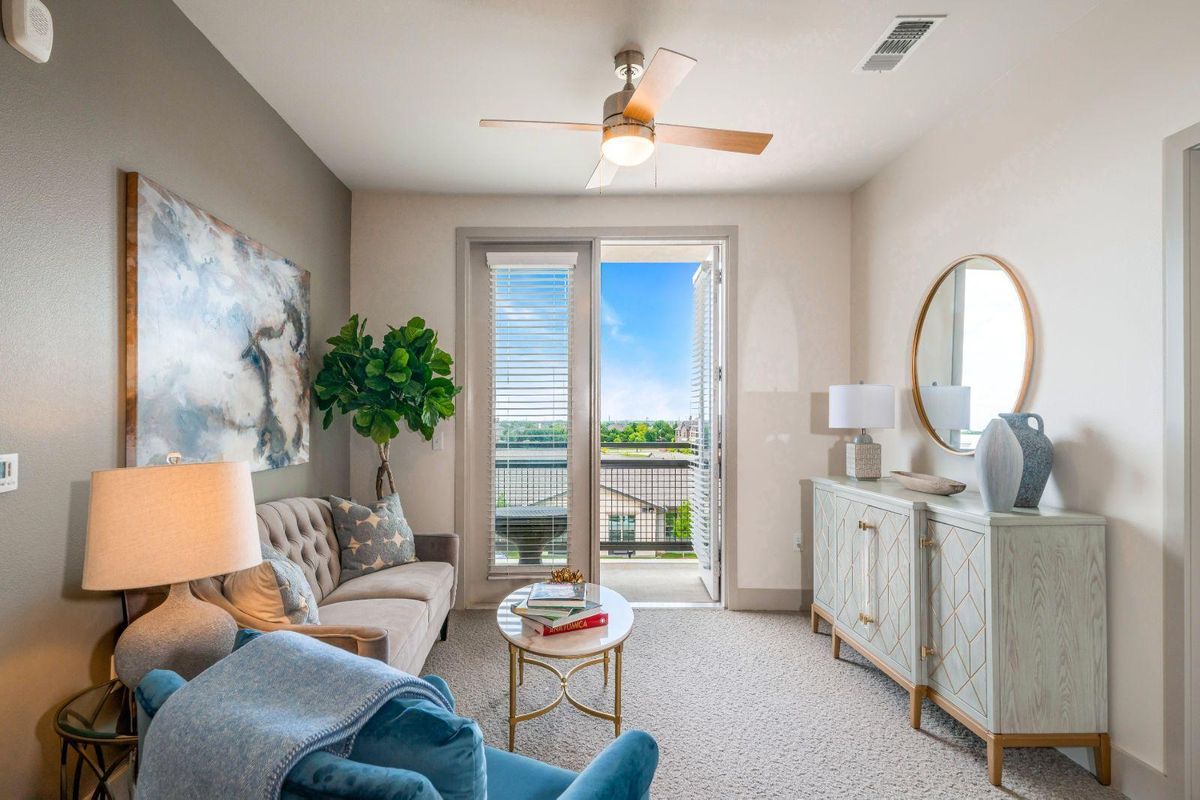 A modern and cozy living room with elegant decor and a bright balcony view.