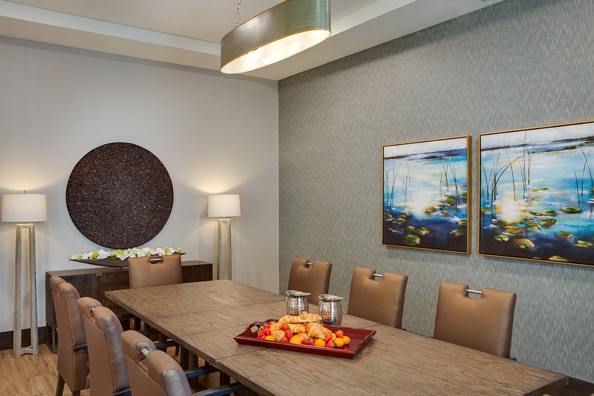 A modern dining room with elegant decor and artwork.