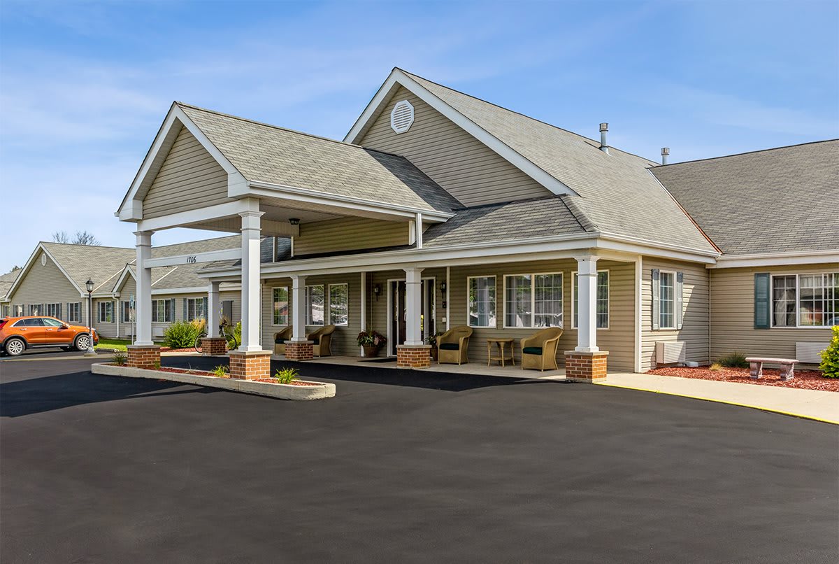 A large residential building with a porch and covered entrance.