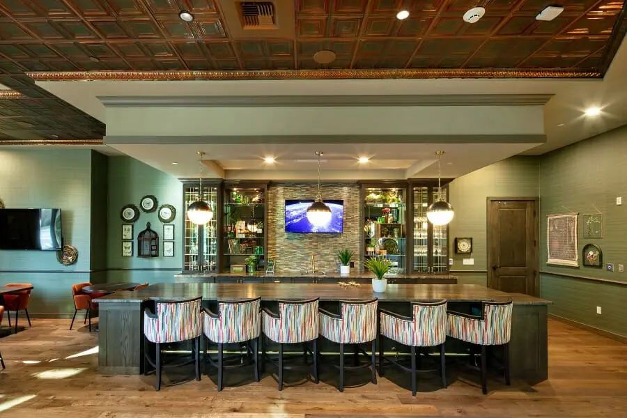 A modern bar interior with stylish seating and warm lighting.