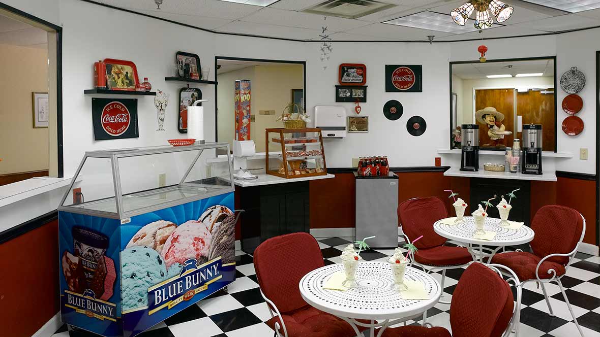 A retro-style ice cream shop with a checkerboard floor and vintage decorations.