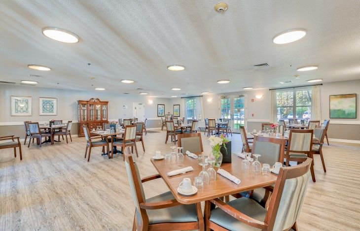 An empty restaurant dining area with neatly arranged tables and chairs.
