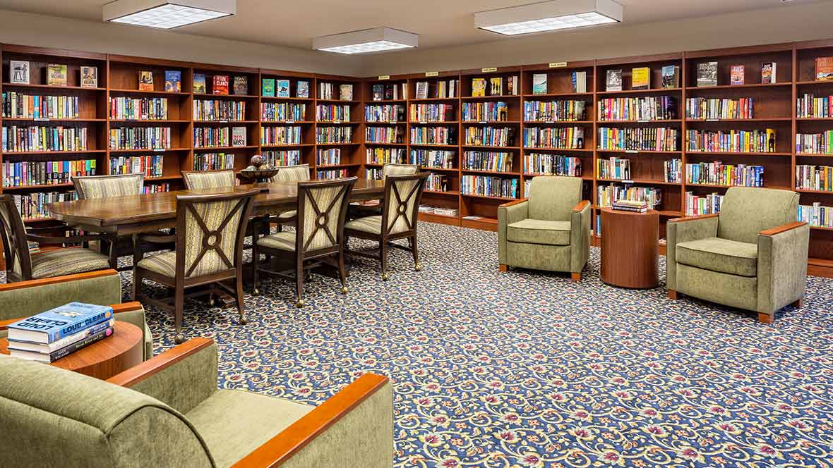 A cozy library with bookshelves and comfortable seating.