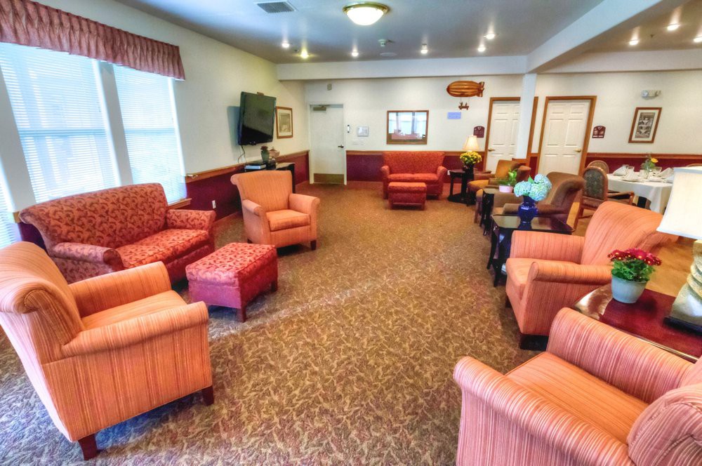 A cozy living room with comfortable chairs and a television.
