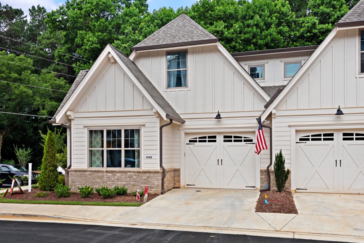 A modern single-family home with a garage and an American flag.