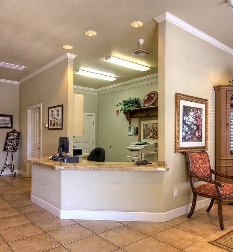 A welcoming reception area with a desk, computer, and comfortable seating.