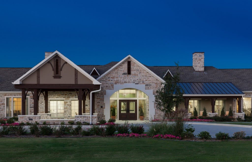 A beautifully lit residential house at night.