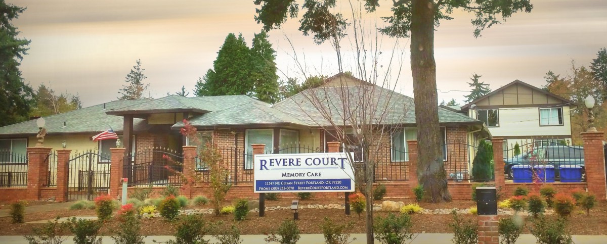 A photo of Revere Court, a memory care facility surrounded by trees and landscaping.