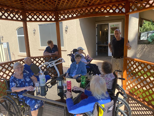 Residents enjoying a social gathering in a gazebo.