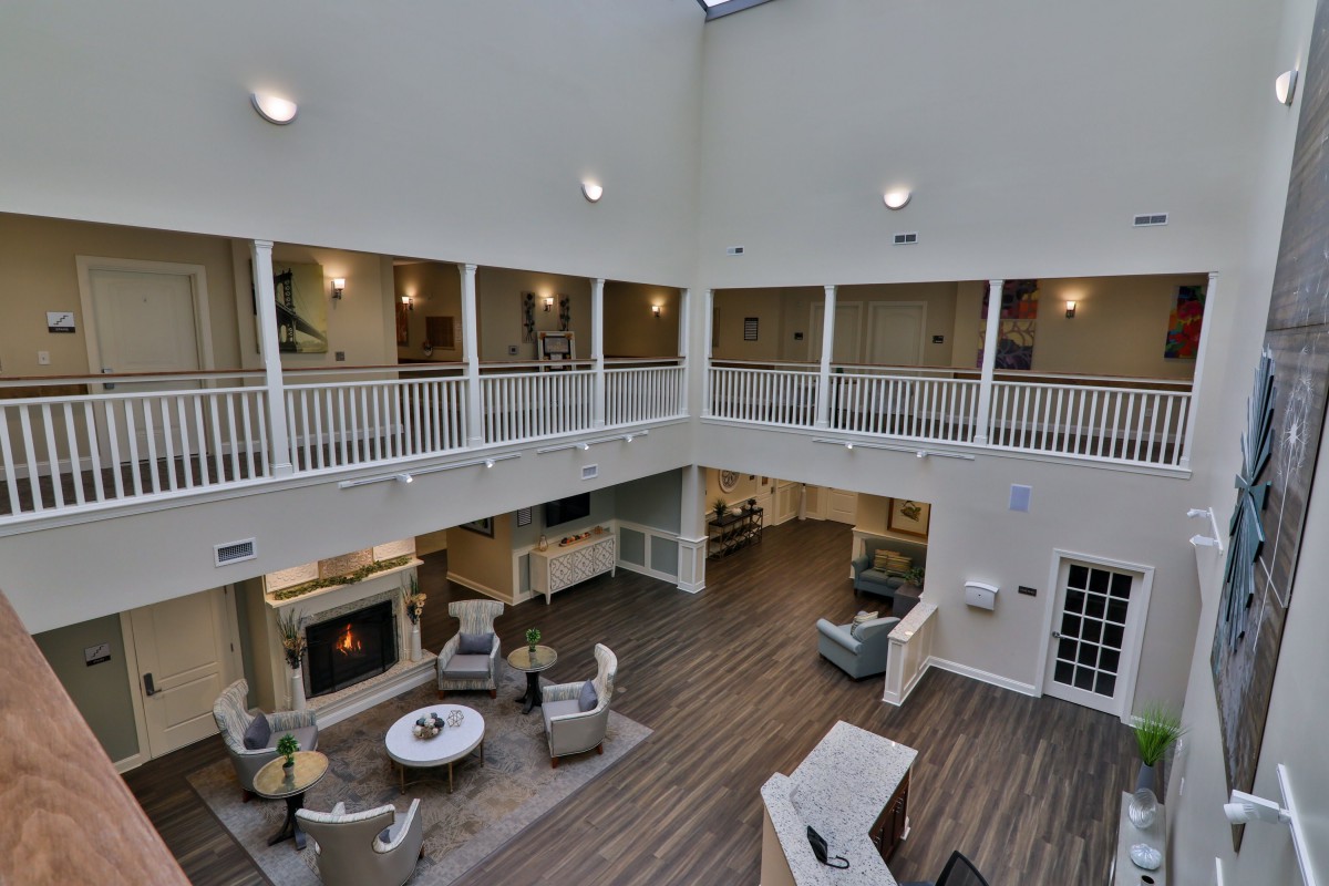 A spacious lobby with a seating area, high ceiling, and surrounding balconies.
