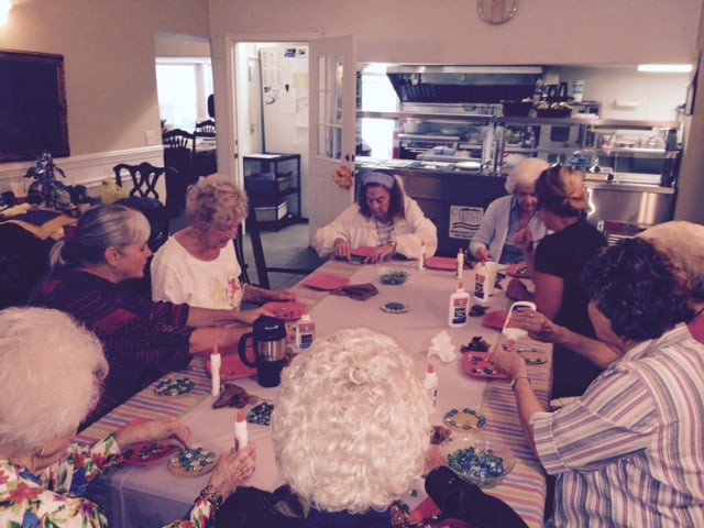 A group of senior individuals enjoying a card game together at a table.