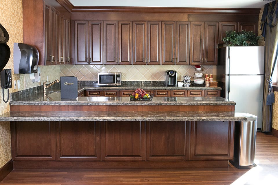 A modern kitchen with wooden cabinets and various appliances.