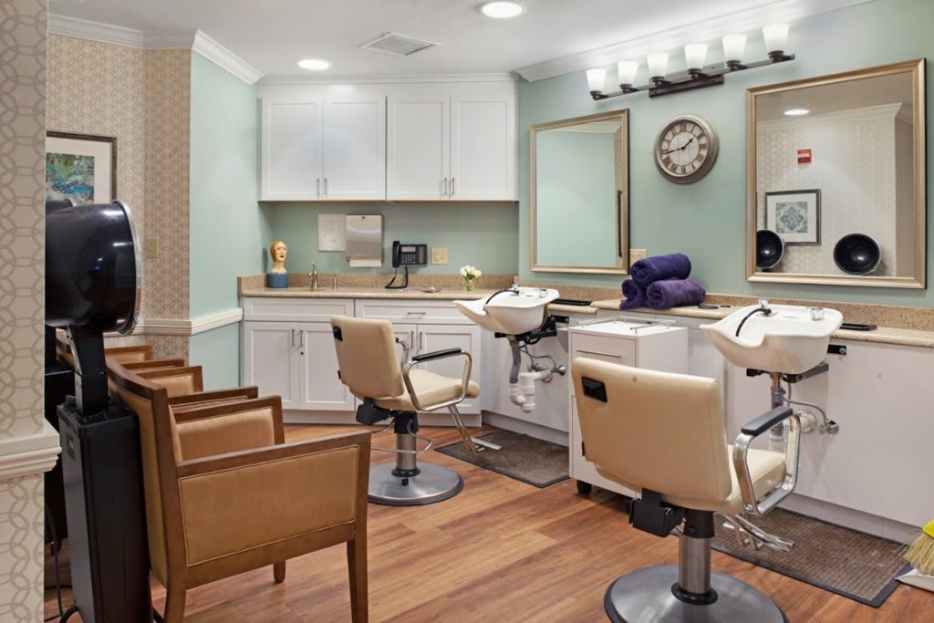 A modern hair salon with stylish chairs and mirrors, offering a clean and welcoming environment.