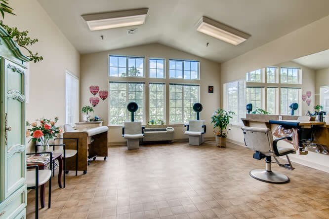A spacious and bright salon interior with styling chairs and mirrors.