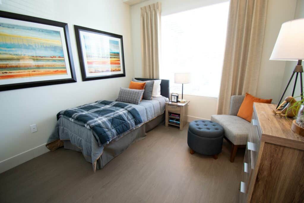 A cozy, modern bedroom with a single bed, stylish decor, and natural light.