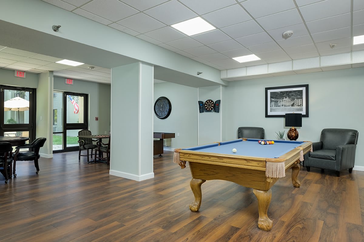A modern game room featuring a pool table and stylish interior design.