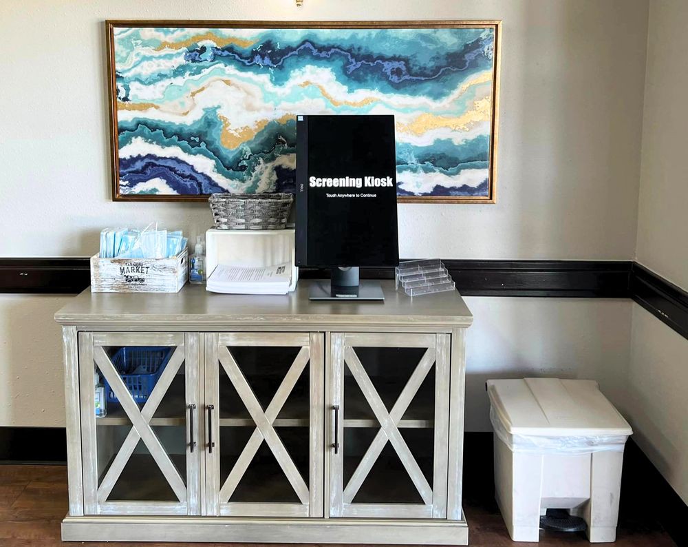A stylish interior featuring a decorative cabinet with an abstract artwork above.