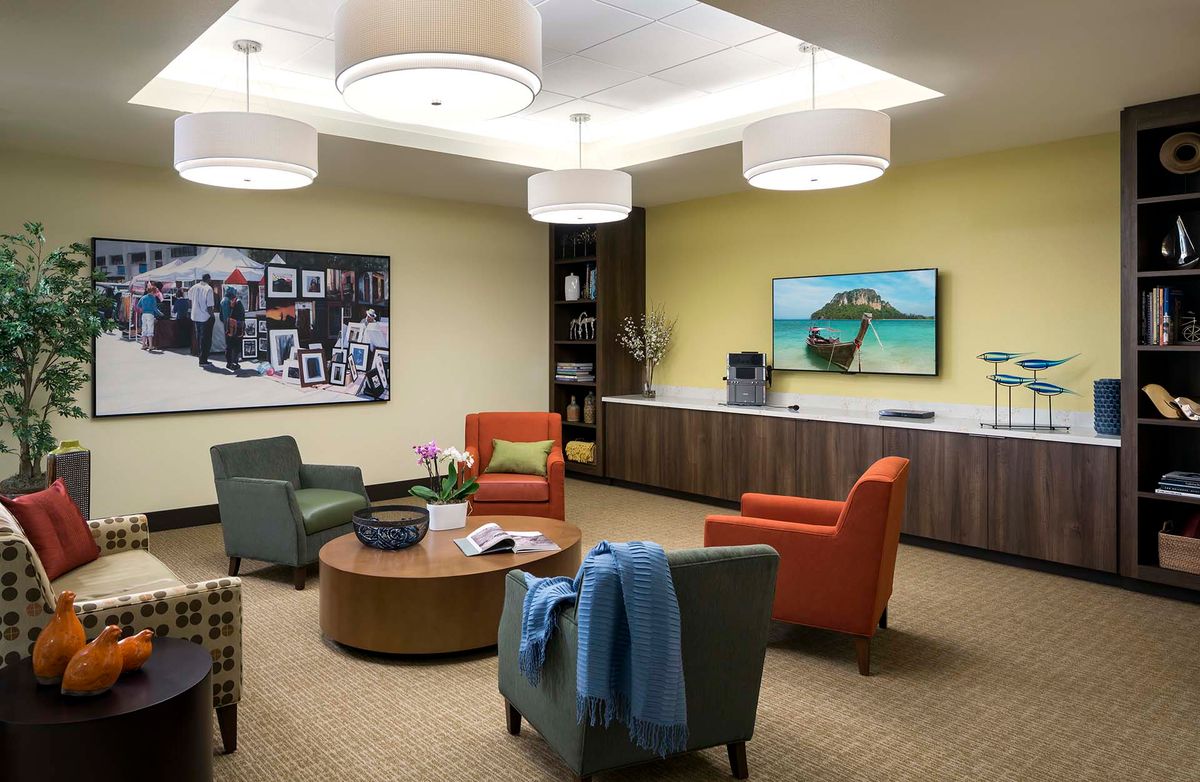 A modern waiting room with comfortable seating and colorful decor.