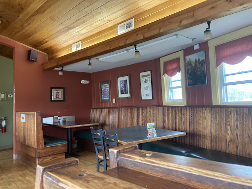 A cozy dining corner featuring wooden accents and framed artwork.