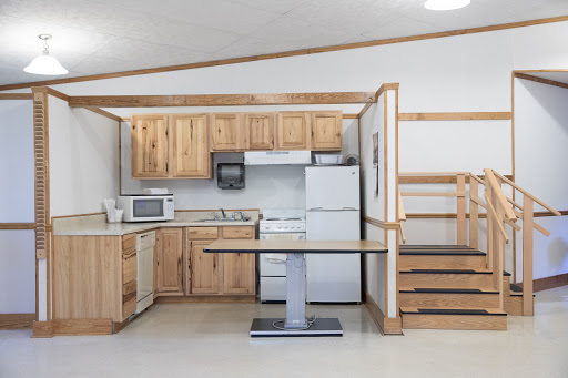 A modern kitchen featuring wooden cabinets and essential appliances.