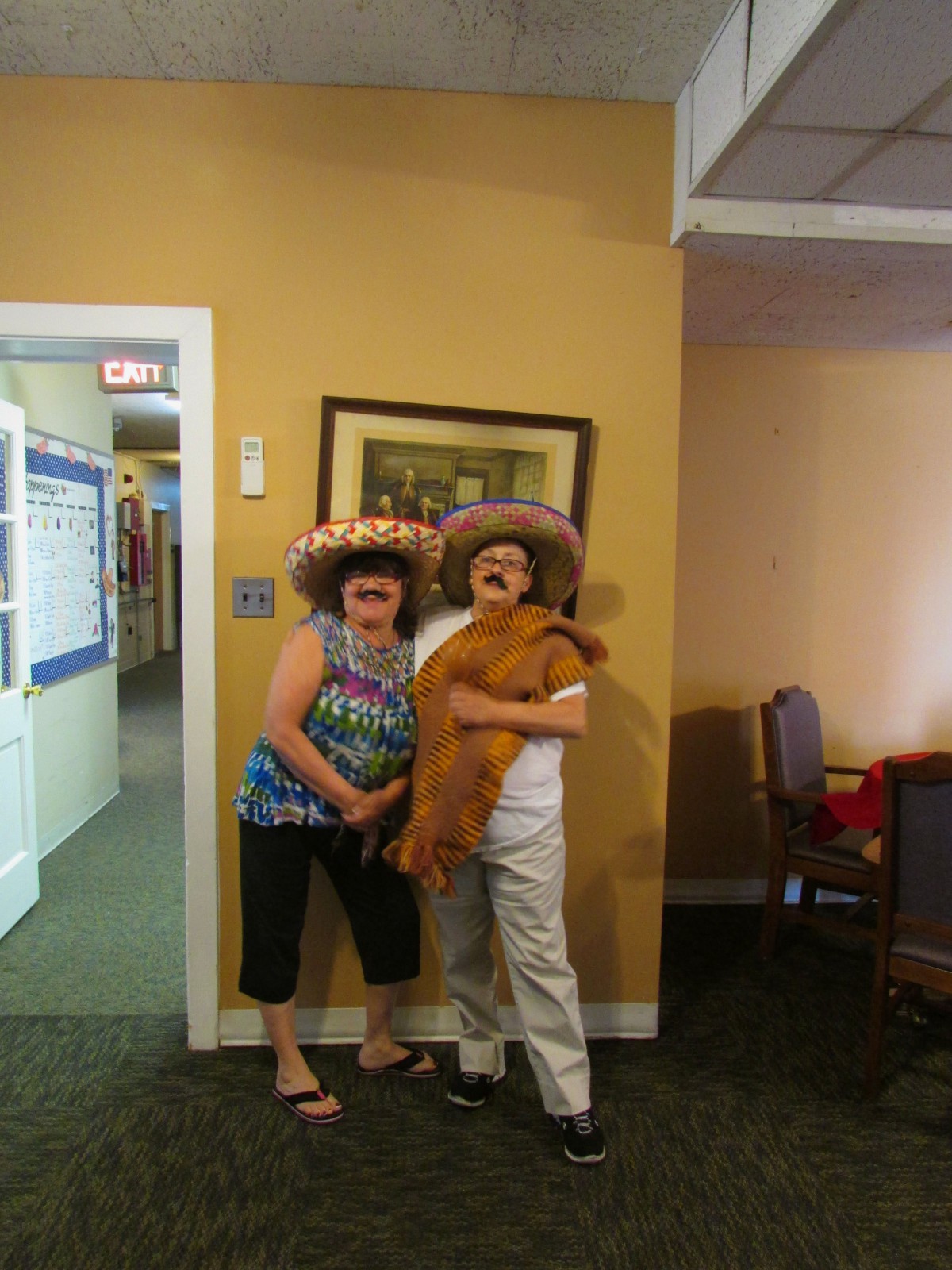 Two people in playful costumes posing indoors.