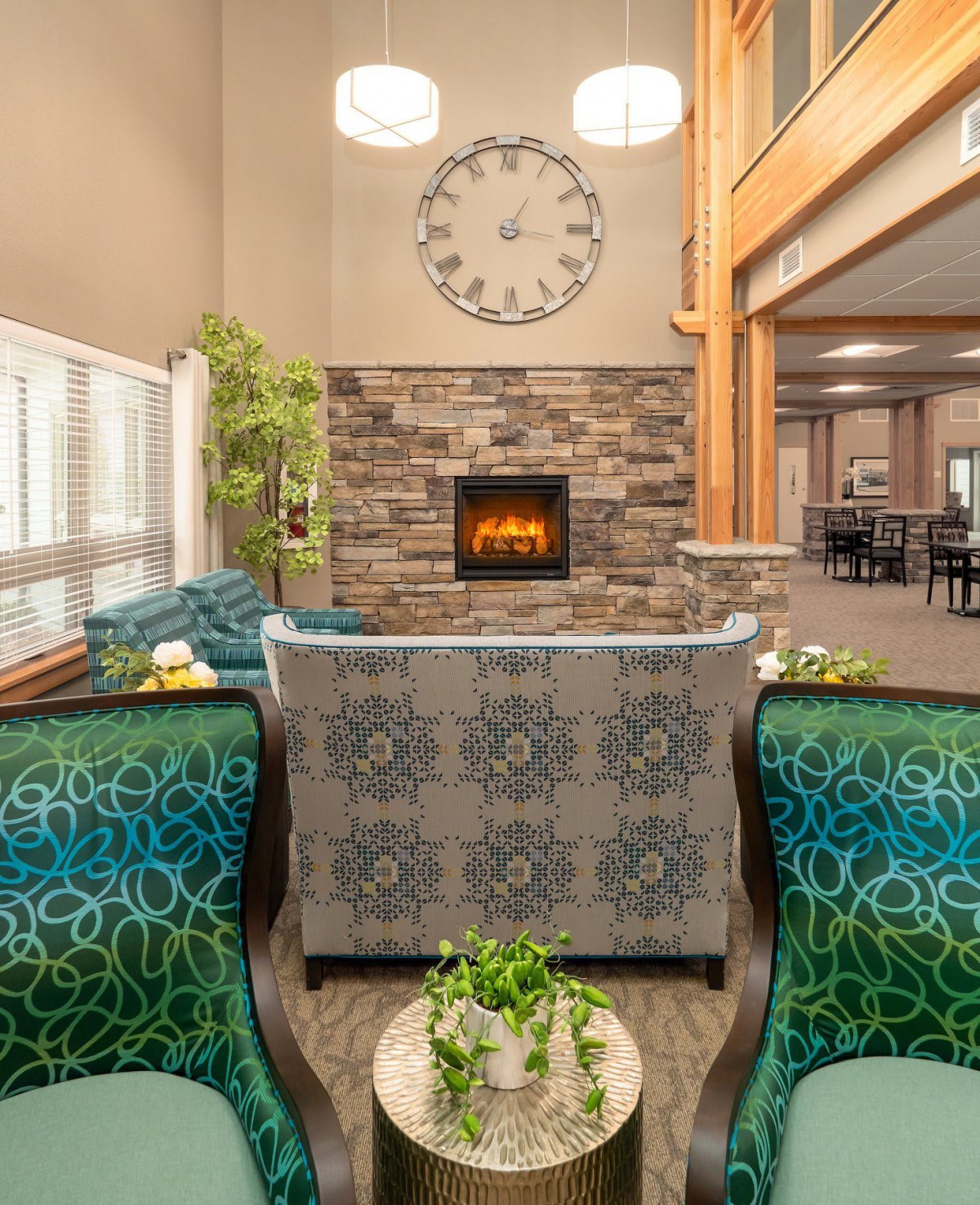 A cozy living room with a central fireplace, stylish furniture, and decorative elements.
