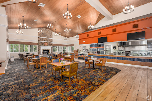 A cozy dining area with wooden accents and a vibrant carpet, perfect for enjoying meals.
