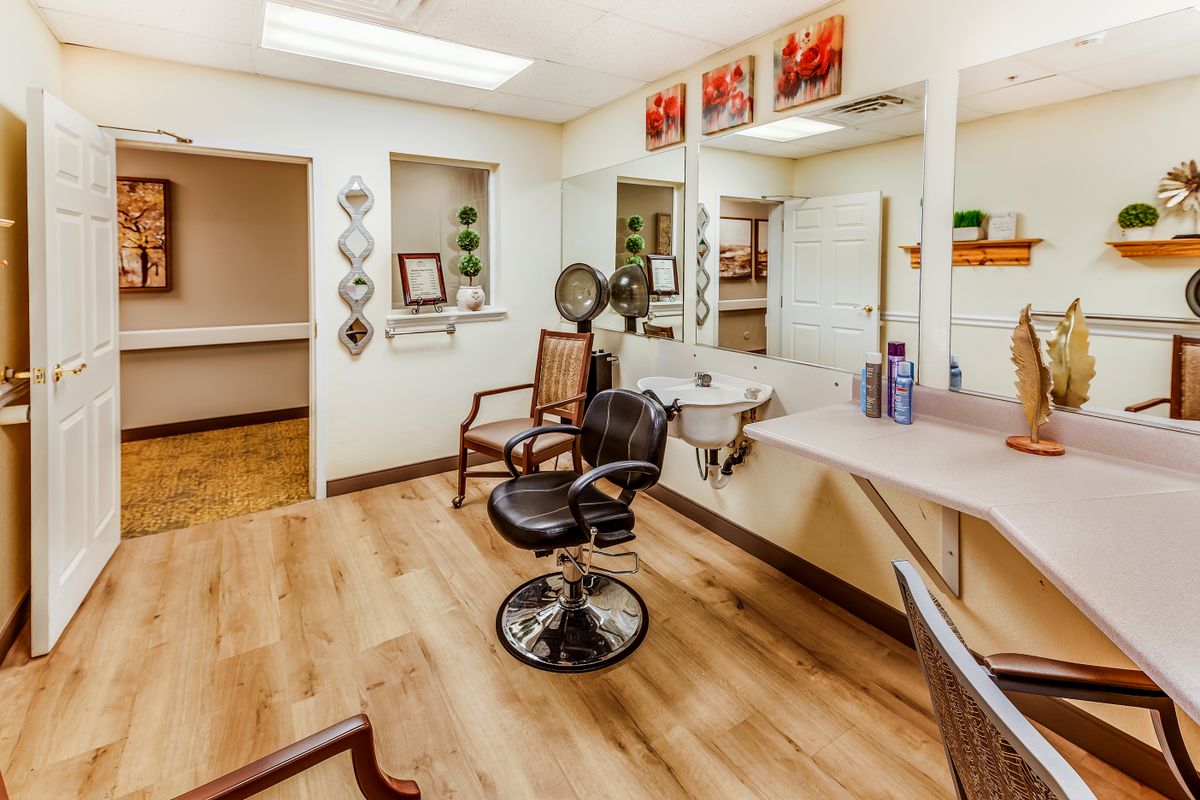 A cozy and well-decorated salon interior with chairs and mirrors ready for customers.
