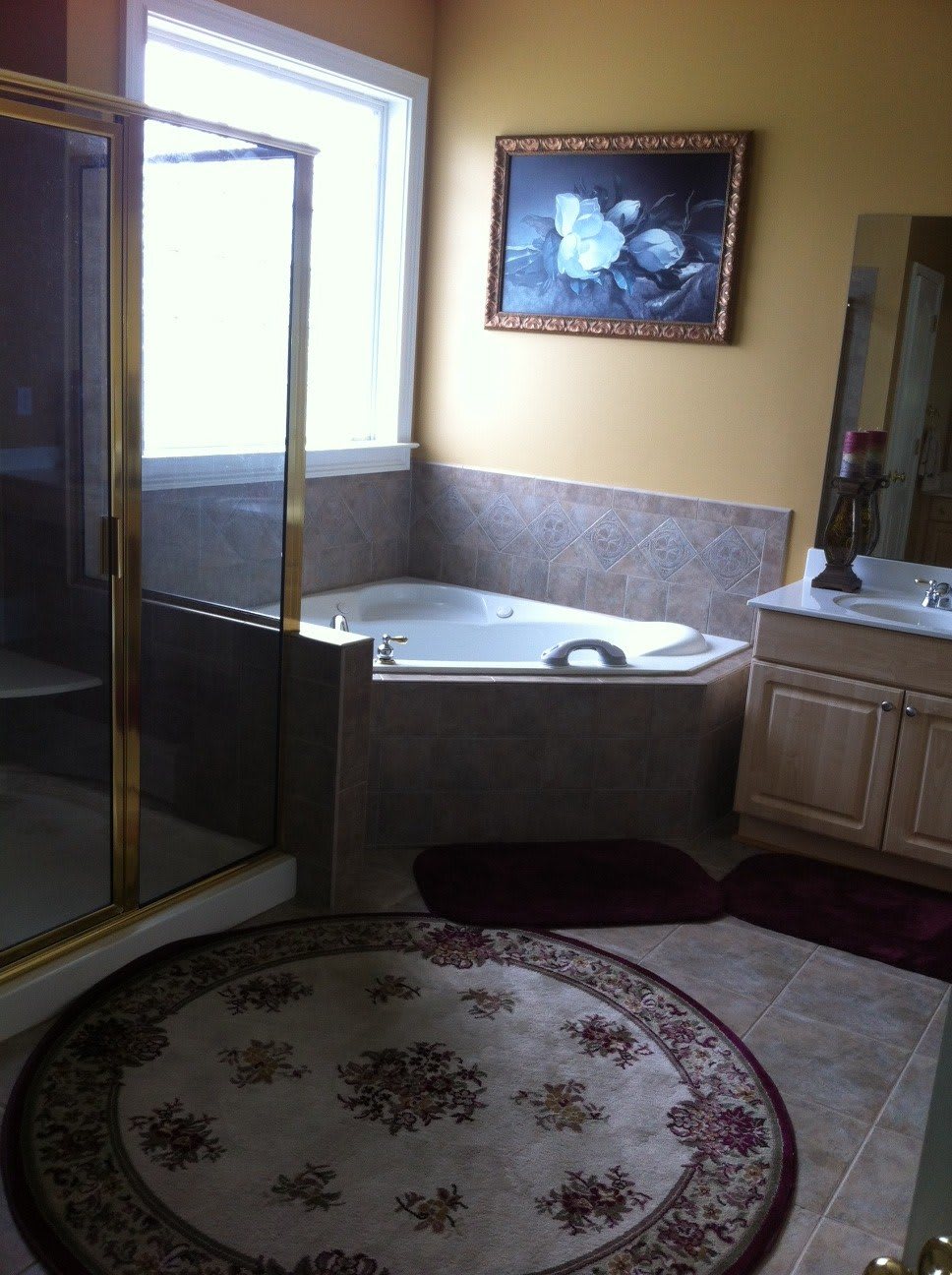 A modern bathroom with a corner bathtub, separate shower, and elegant decor.