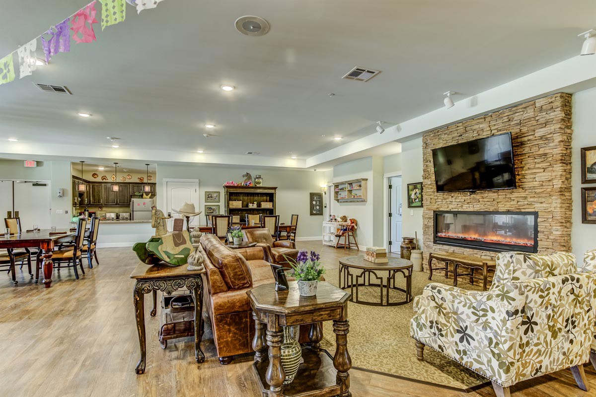 A spacious and well-decorated living room with comfortable seating, a fireplace, and modern amenities.