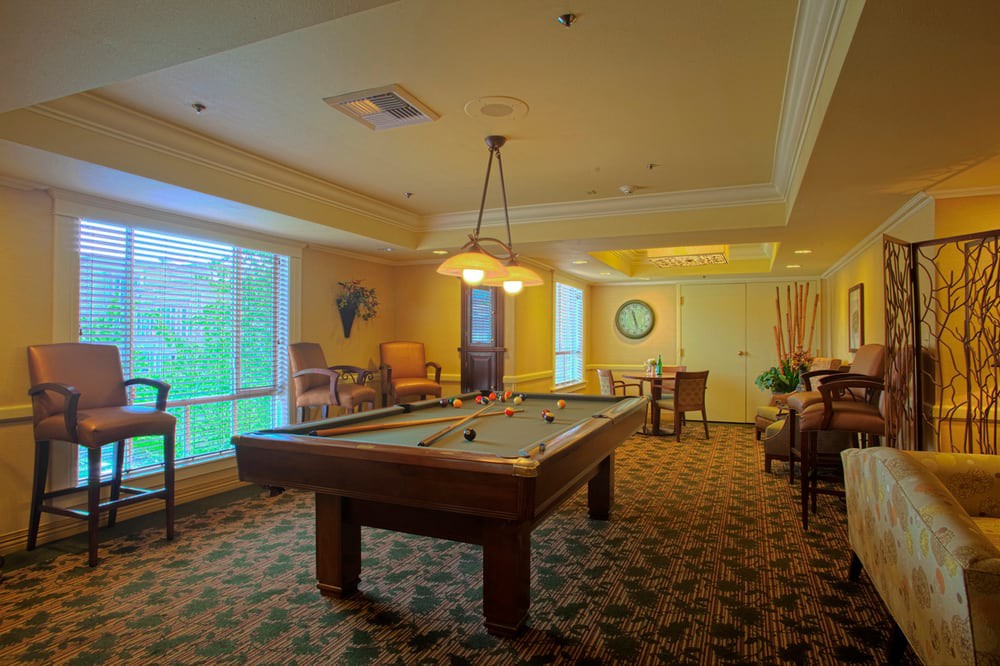 Cozy game room with a pool table and comfortable seating.