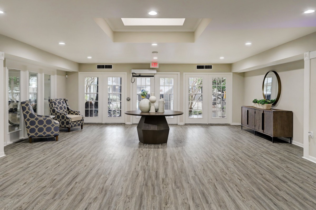 A modern lobby area with elegant decor and wood flooring.