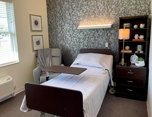 A well-appointed hospital room featuring a bed, nightstand, and decorative elements.