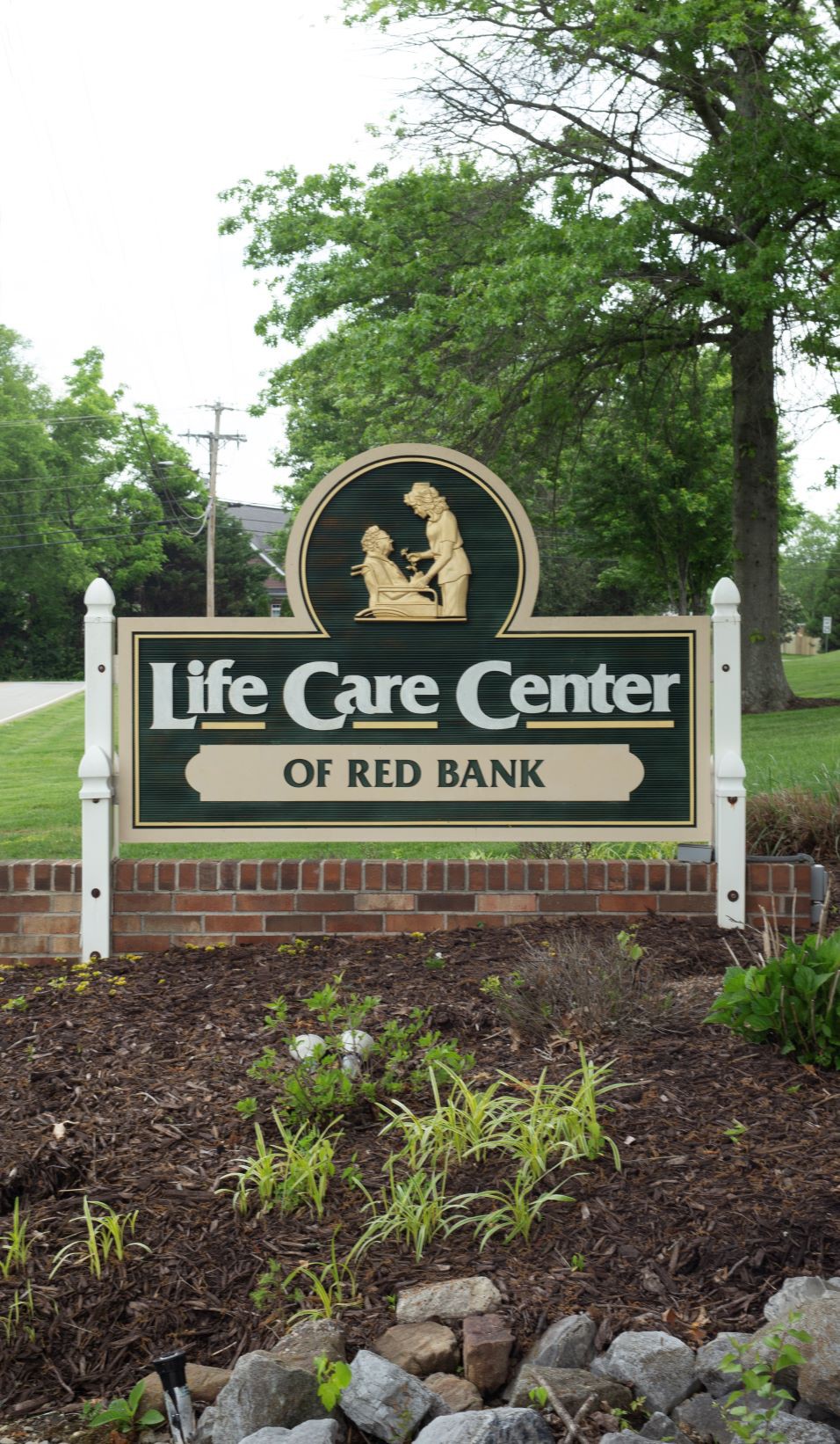 Sign for Life Care Center of Red Bank located outdoors amidst greenery.