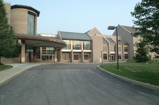 A view of a modern building with a welcoming entrance and driveway.
