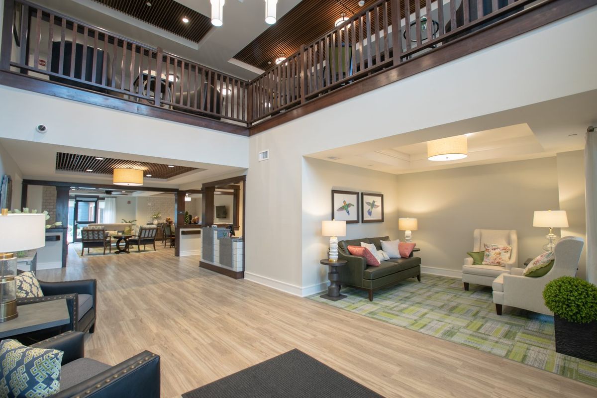 A spacious and elegantly designed living area with modern furniture and sophisticated lighting.