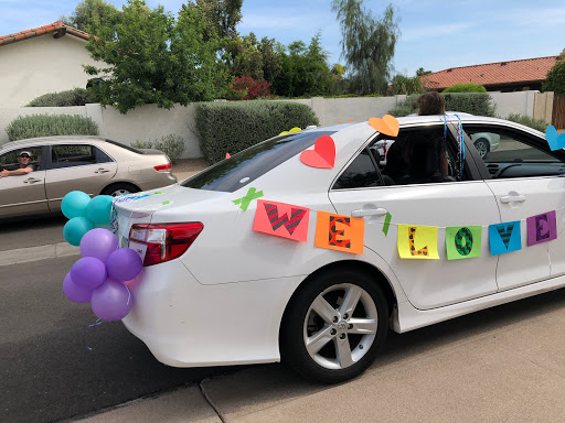 A festive car adorned with colorful decorations and balloons, ready to celebrate a special occasion.