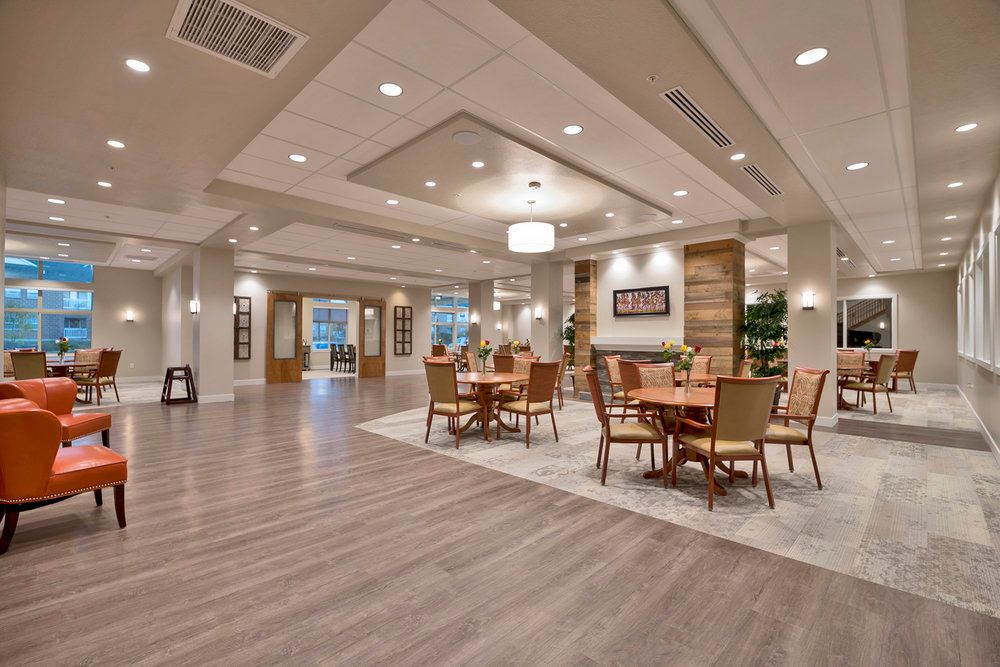 A modern and spacious dining area with elegant lighting and wooden flooring.