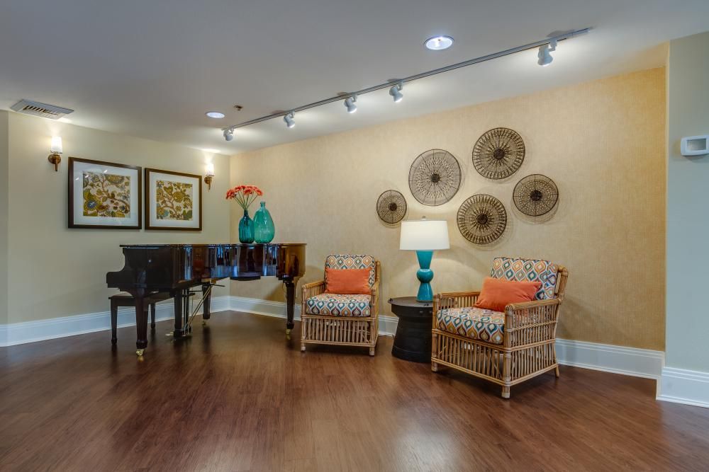 Cozy living room interior with wicker chairs and decorative artwork.