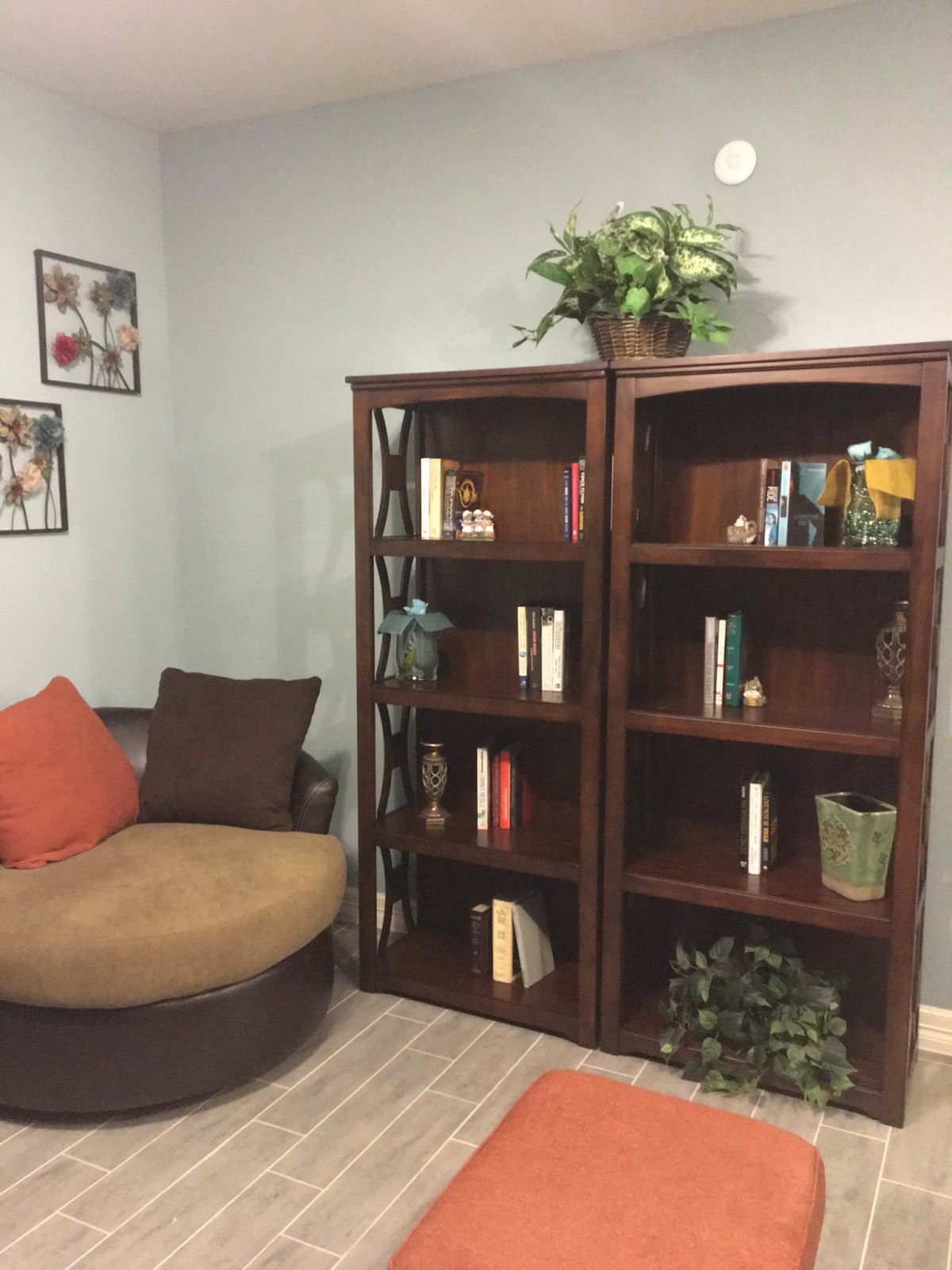 A cozy living room corner featuring a bookshelf and a comfortable chair.