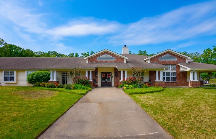 A suburban home with a spacious driveway and well-maintained lawn.
