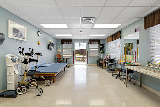A well-equipped therapy room in a healthcare facility, designed for rehabilitation and physical therapy sessions.