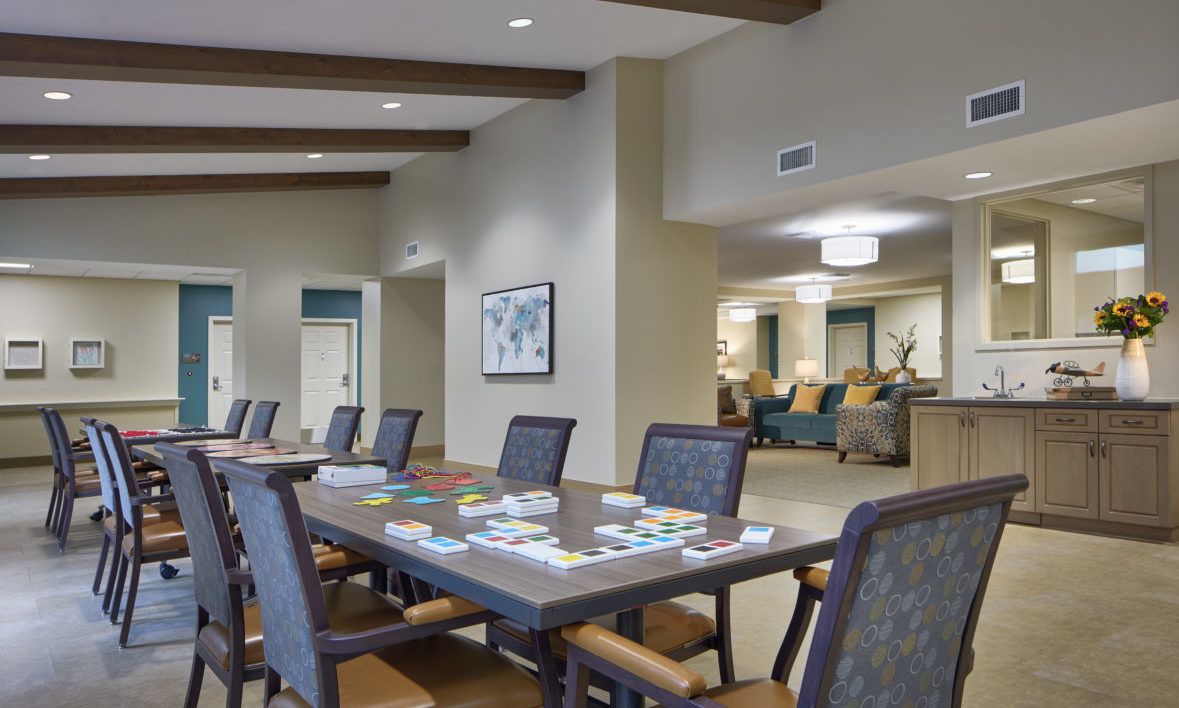 A communal room with a table and chairs set up for games.