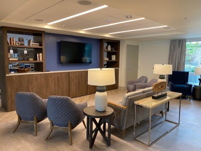 A modern living room with comfortable seating, a large television, and stylish decor.